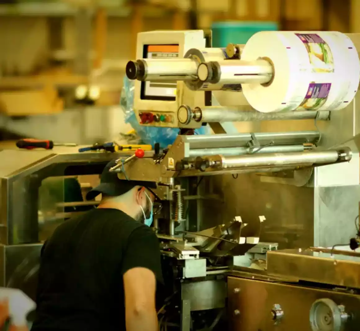 technician examining food packaging equipment